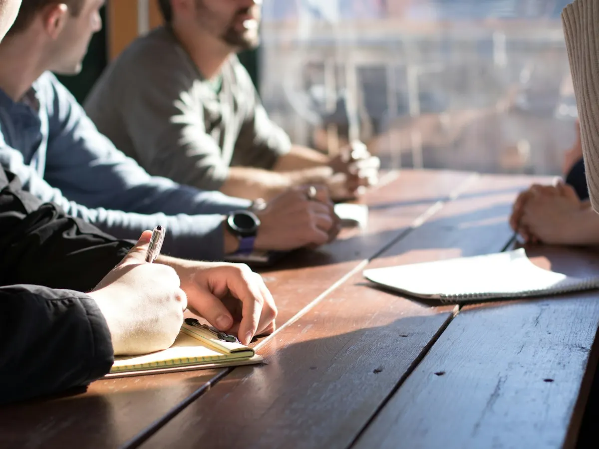 Team discussing plans around a table