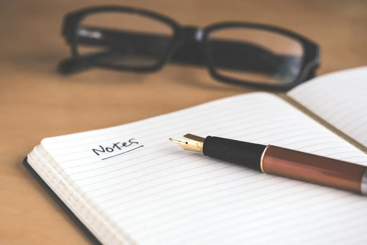 Writer drafting content in a notebook