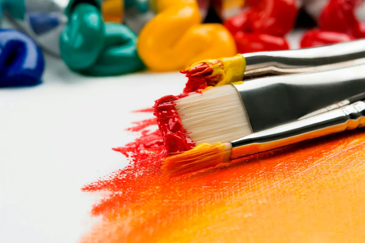 Paint brushes and bright paint for illustration