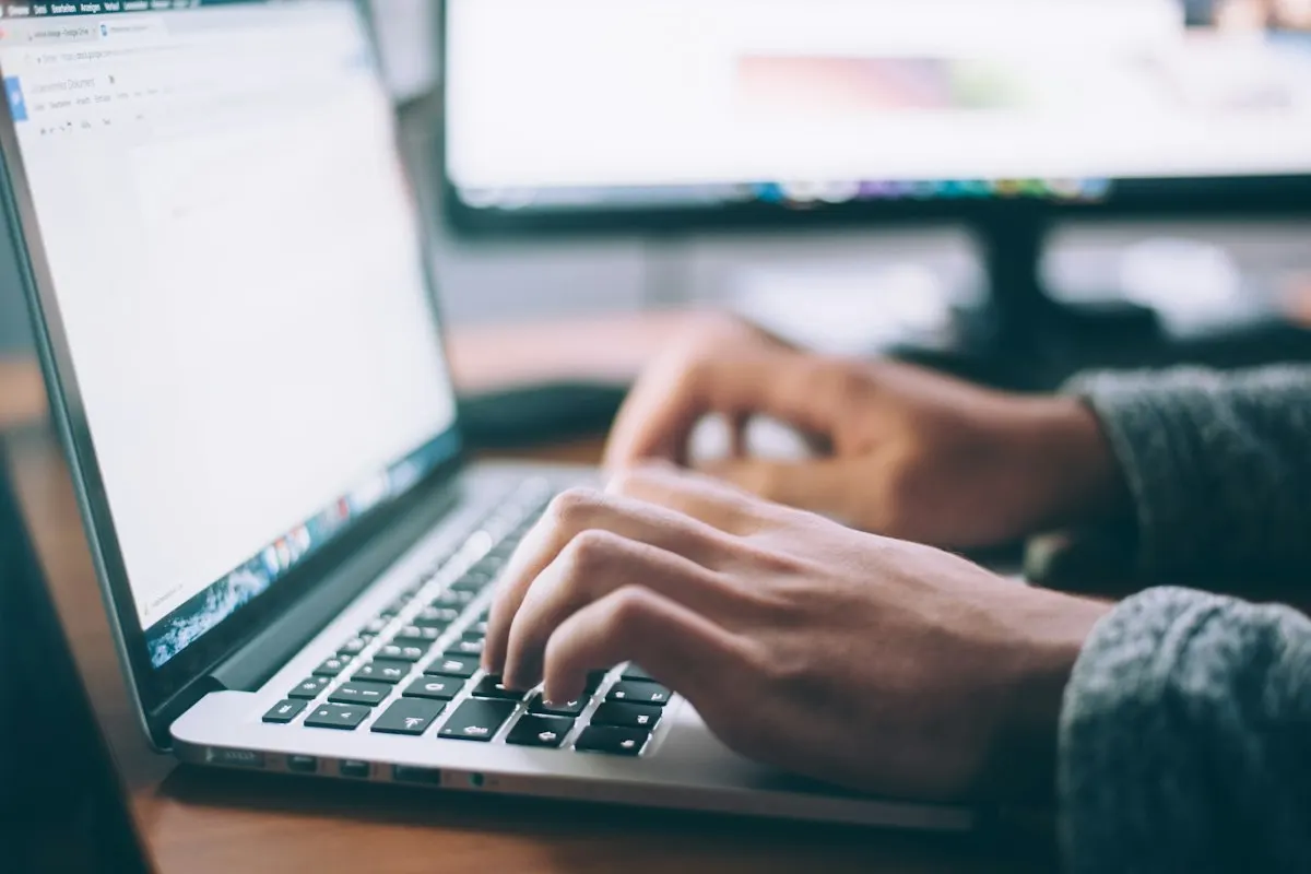 Copywriter typing on a laptop